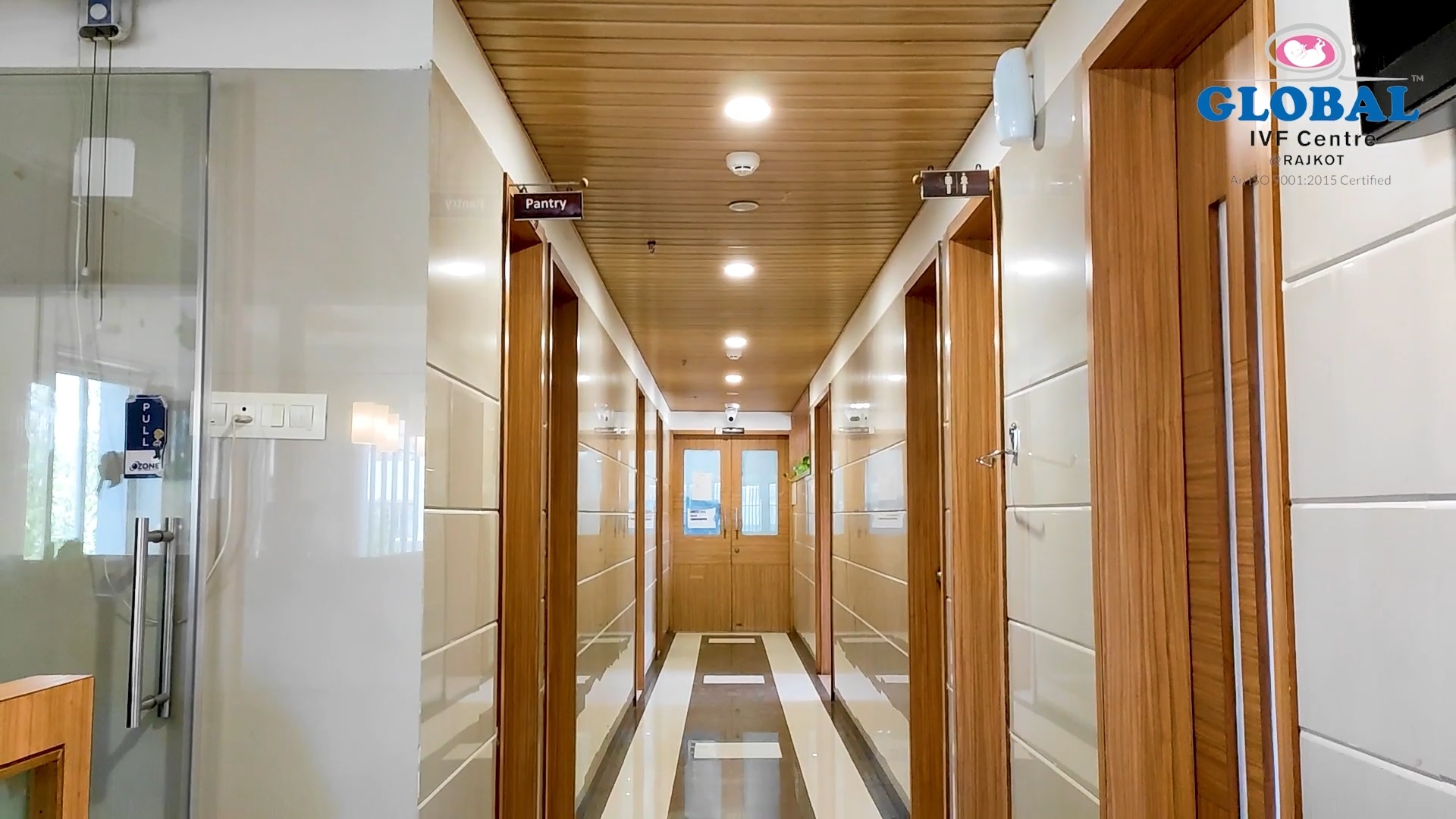 Clean, well-lit second-floor corridor leading to OT and pantry at Global IVF Centre Rajkot