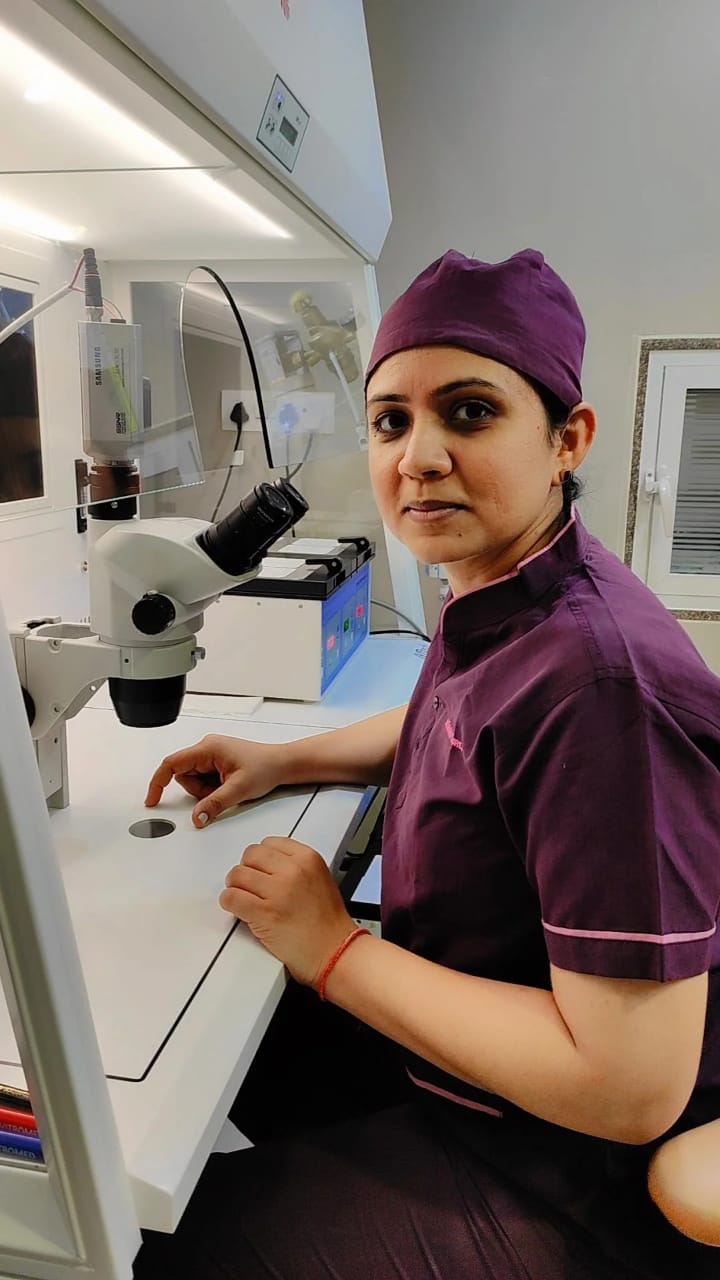 Embryologist working at a stereo microscope inside the class-100 clean-air IVF laboratory