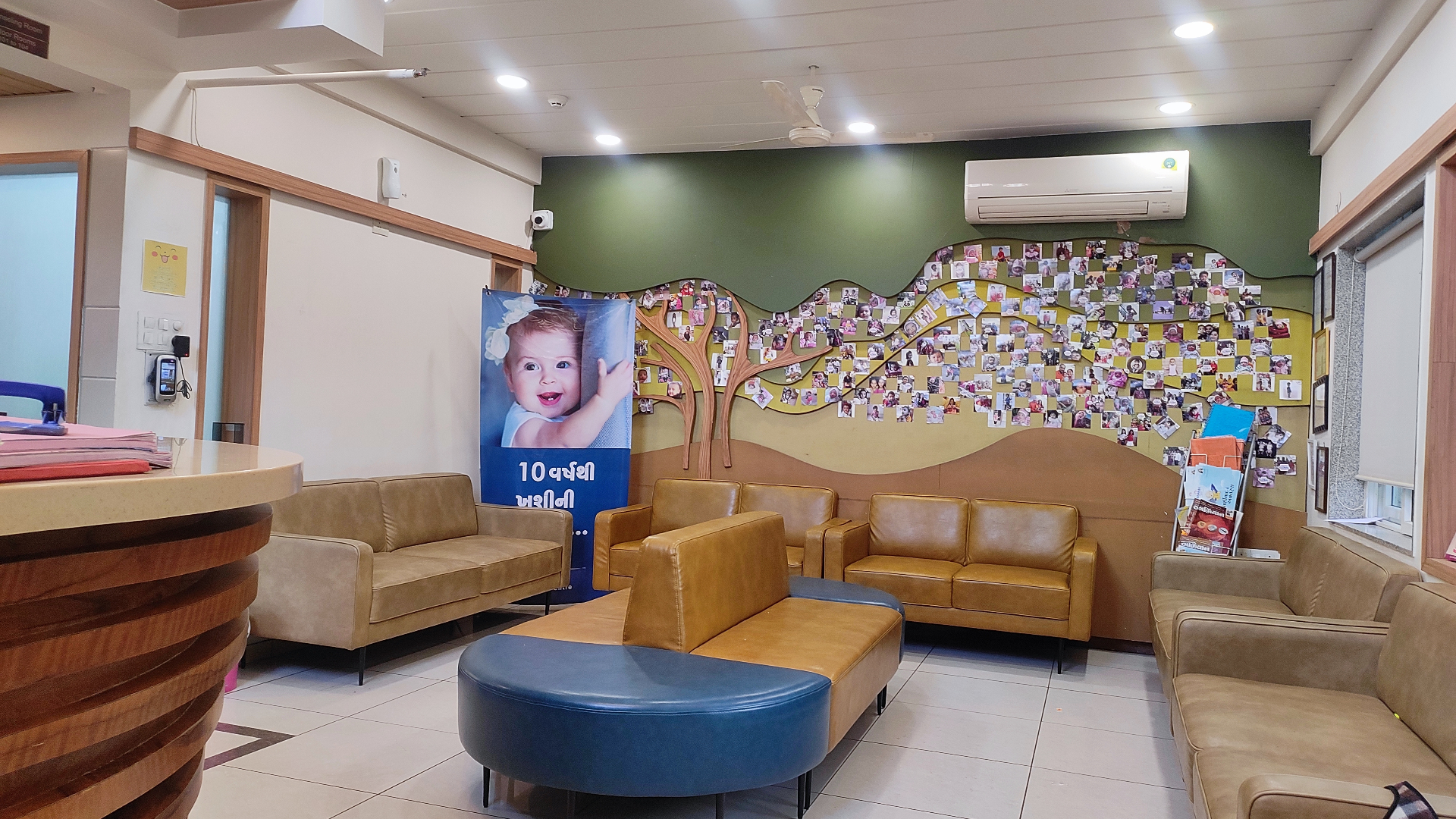 Ground-floor waiting lounge with success-story wall at Global IVF Centre Rajkot