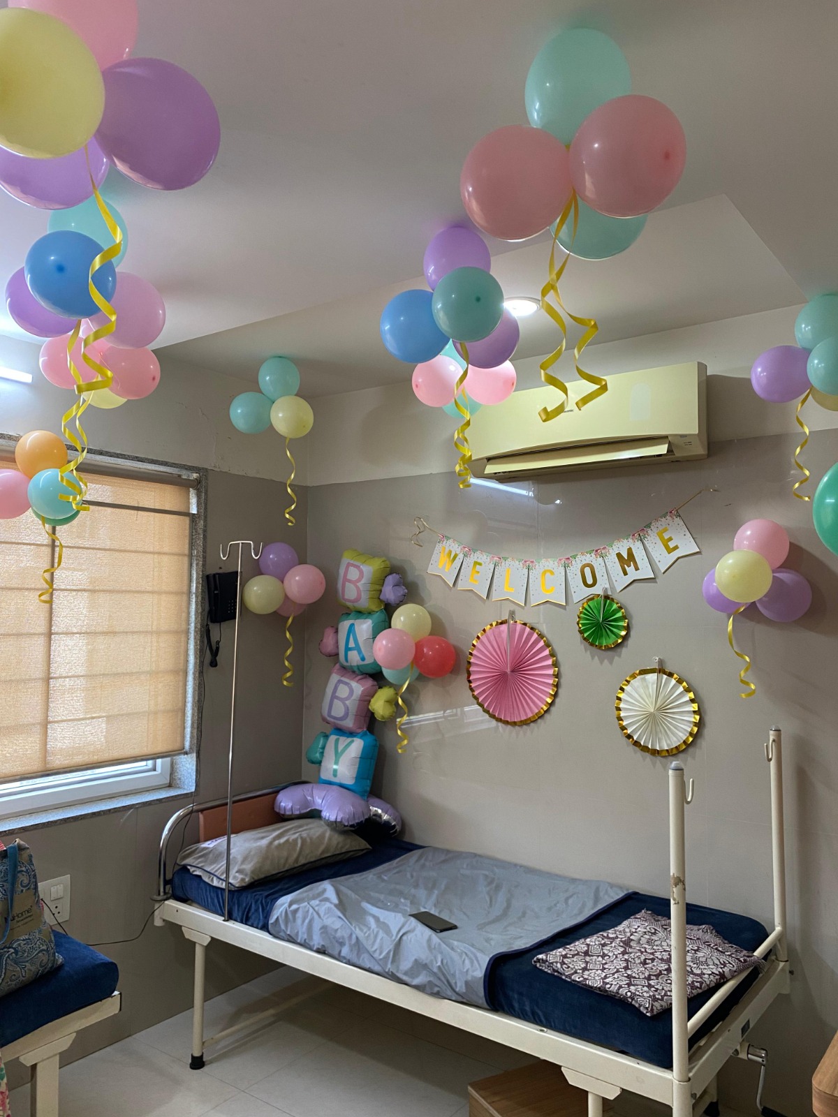 Recovery room decorated with pastel balloons and a Welcome Baby banner at Global IVF Centre